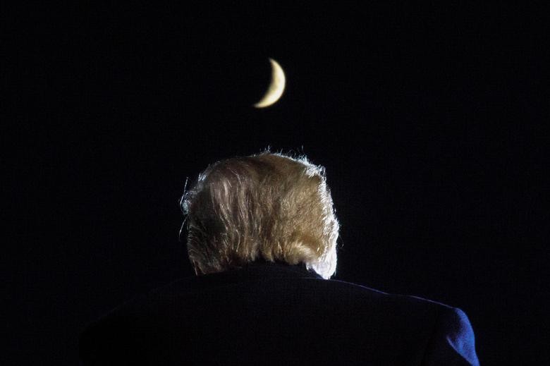 A moon is seen above President Trump during a campaign event at Toledo Express Airport in Swanton, Ohio. REUTERS/Tom Brenner  